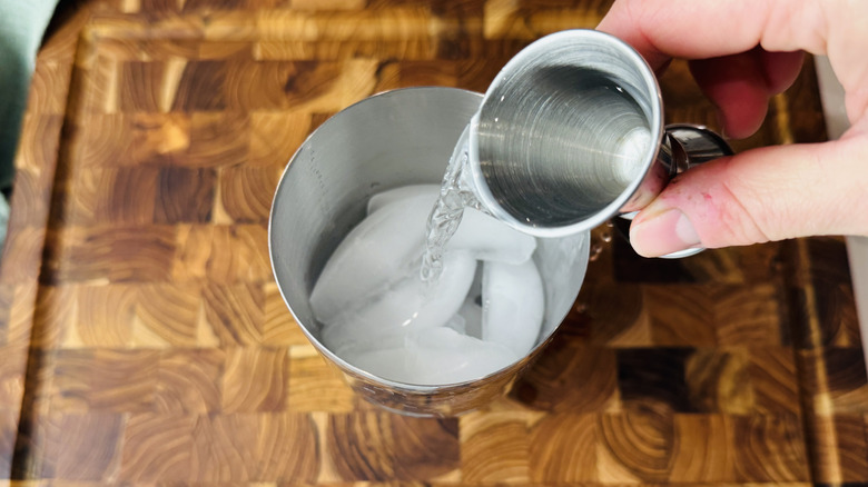 Adding vodka to cocktail shaker