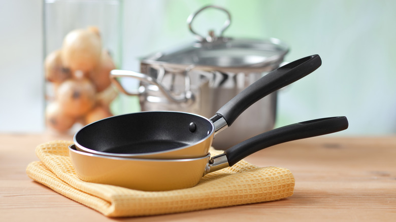 Frying pans on dish towel