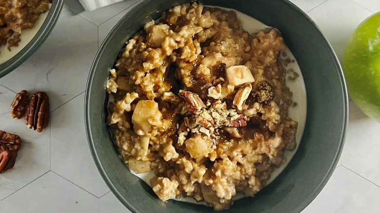 Bowl of oatmeal with nut and apples