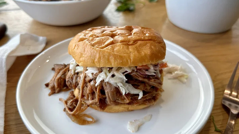 Pulled pork on a sandwich with coleslaw