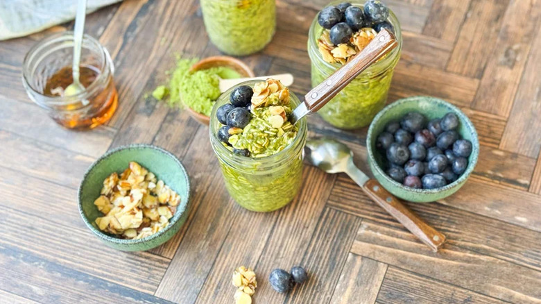 Matcha oats on a table with blueberries