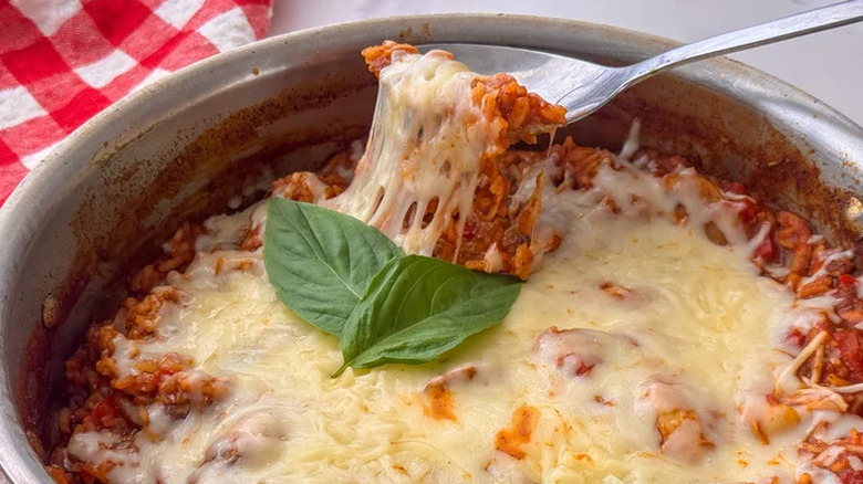 Pizza rice in a pot with basil sprig
