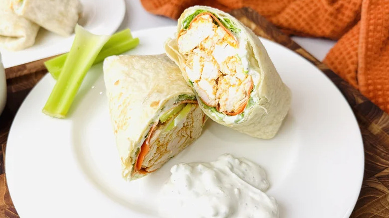 Buffalo chicken wrap on a plate with sauce