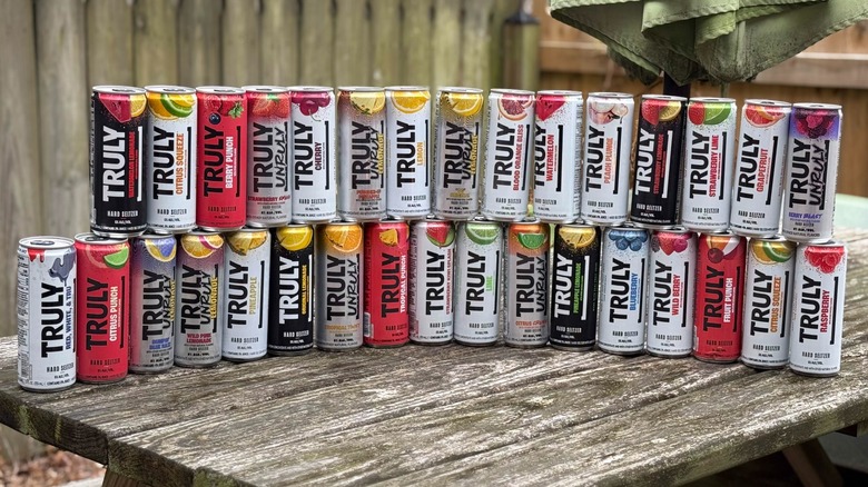 A stack of Truly hard selzers on a picnic table