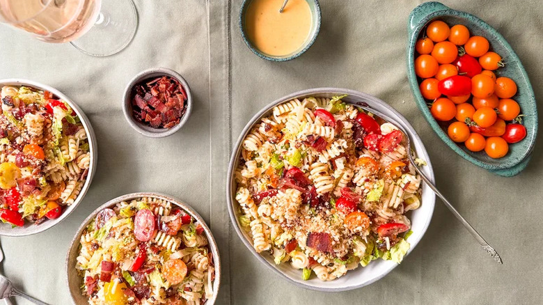 Pasta salad with ingredients on table