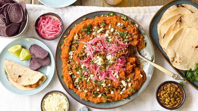 Refried beans on a plate with tortillas