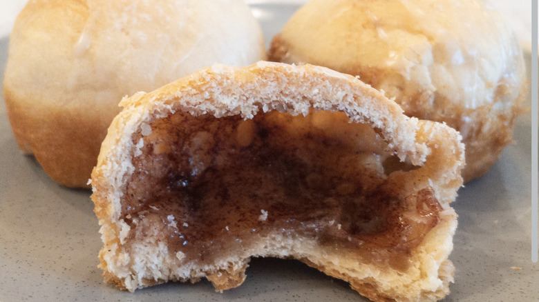 Half of a crescent roll puff with a cinnamon-sugar marshmallow filling.