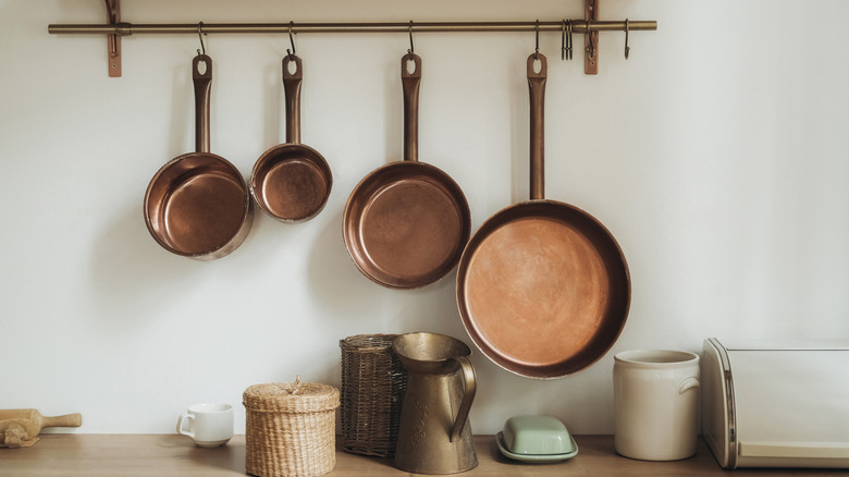 vintage copper pots hanging in a kitchen