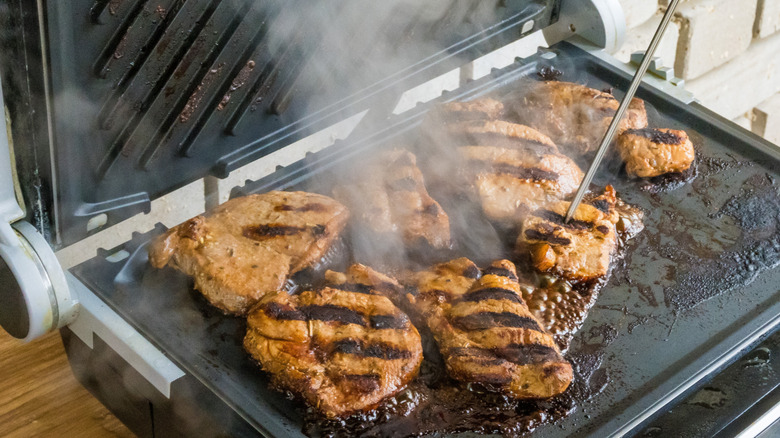 checking steak readiness with thermometer
