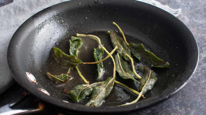 fried sage leaves in a pan