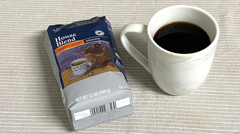 Aldi house blend coffee in bag with a cup of brewed coffee
