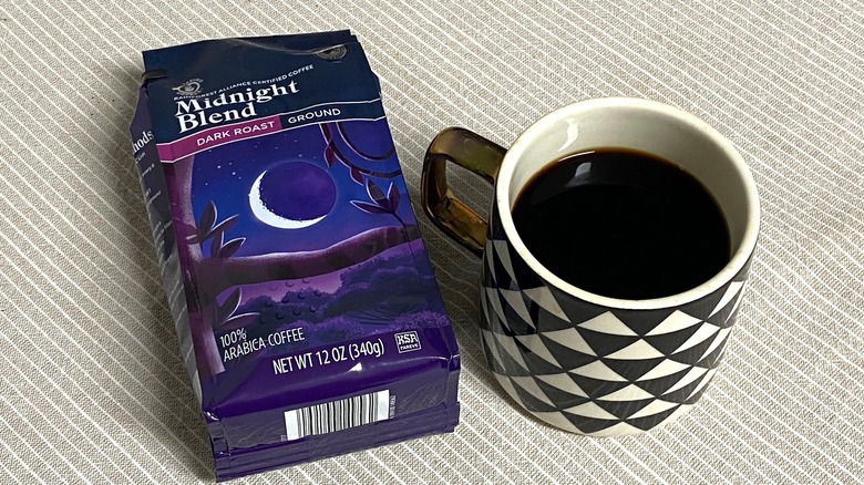 Aldi Midnight blend coffee in bag with a cup of brewed coffee
