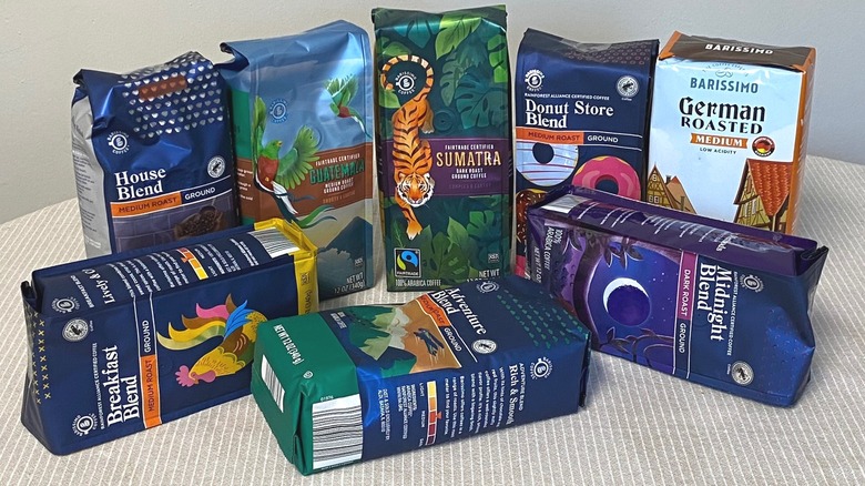 Eight Aldi coffee bags arranged on a table