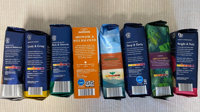 Eight Aldi coffee bags arranged with descriptions facing the viewer