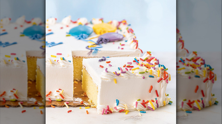 Slice of a white birthday cake with sprinkles