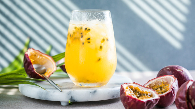 gin and passionfruit cocktail with sliced fruits