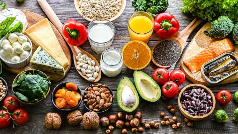 An assortment of ingredients including canned fish, cheese, vegetables, fruits and nuts