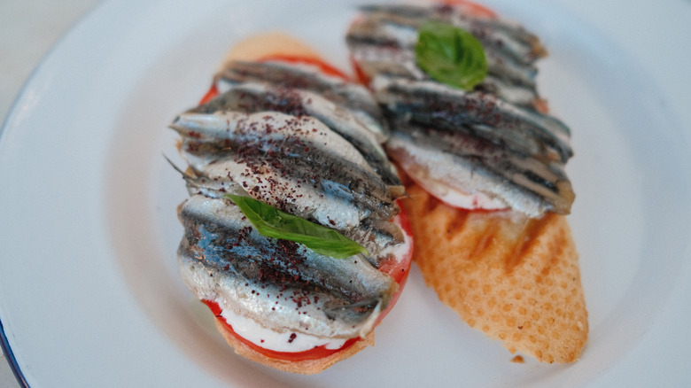 Canend fish on cheese and tomato bruschetta