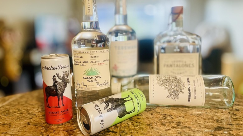 Various celebrity-owned alcohol bottles lying and sitting on countertop
