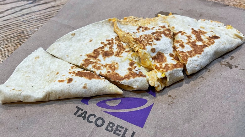 Taco Bell's quesadilla laid out on a paper bag