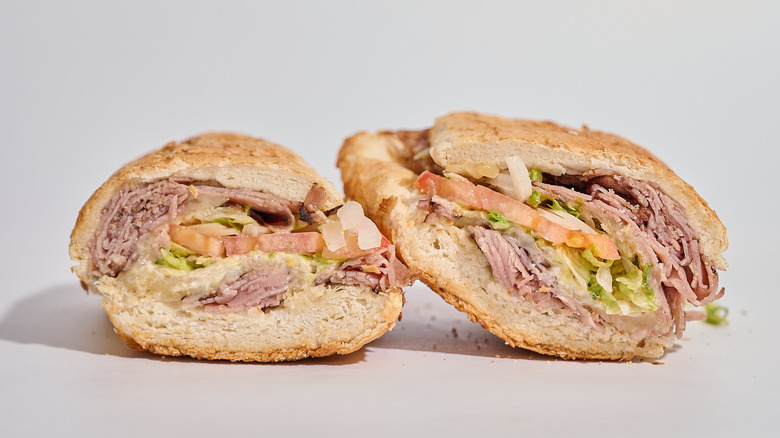 Potbelly's roast beef sub sliced in half on a table