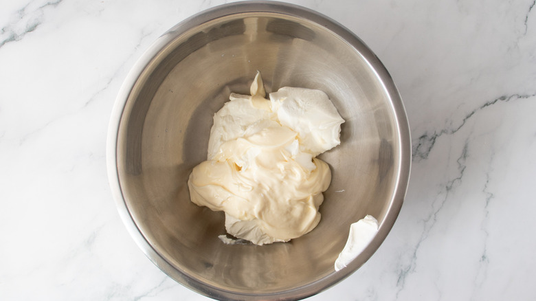 creamy white condiments in a metal bowl