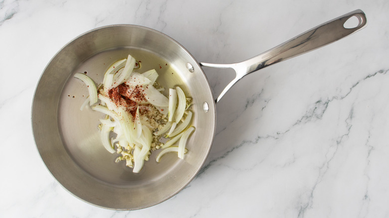 sliced onions in a frying pan