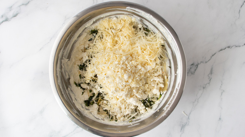 grated cheese in a metal bowl