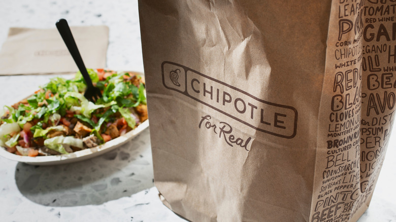 A bag of chips and a bowl from Chipotle