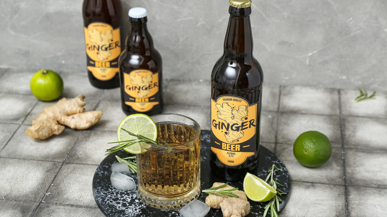 glass of fresh ginger beer surrounded by bottles