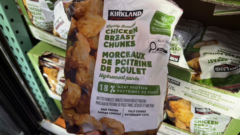 Hand holding Kirkland Signature Lightly Breaded Chicken Breast Chunks
