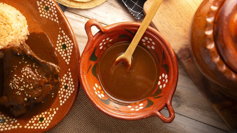 Mexican Mole in an ornately painted porcelain bowl with a wooden spoon