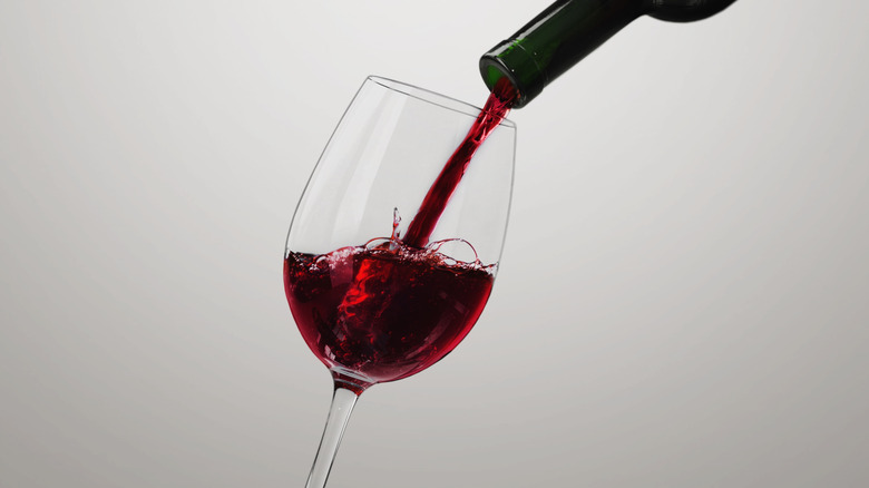 Pouring red wine in glass