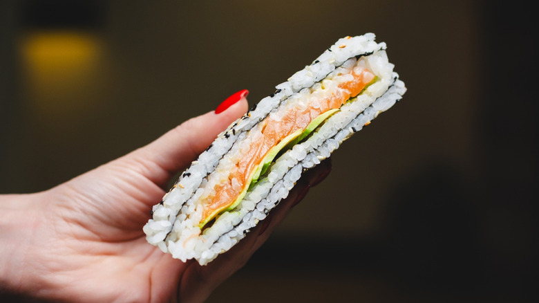 Sushi sandwich held in hand