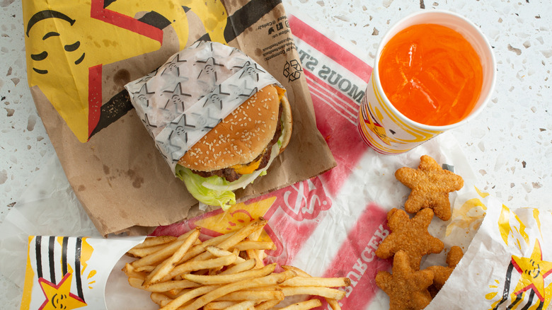 Carl's Jr burger with drink, fries, and nuggets