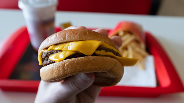 Hand holding burger