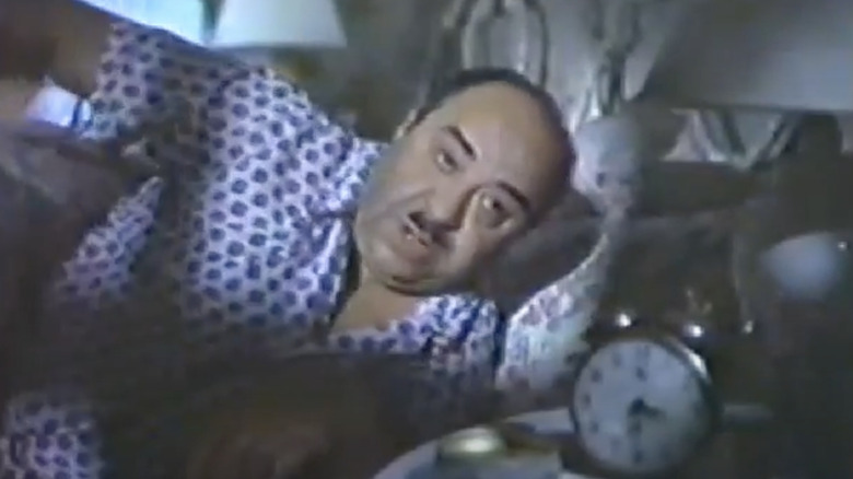 Fred the Baker rises from bed to make donuts.