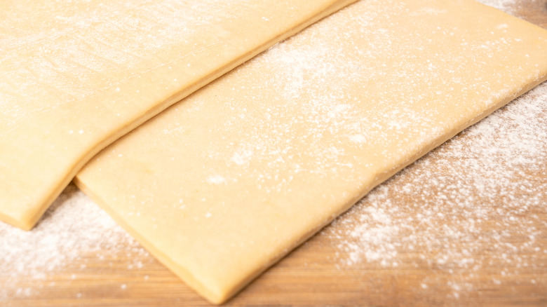 Store-bought pie crust sheets dusted with flour