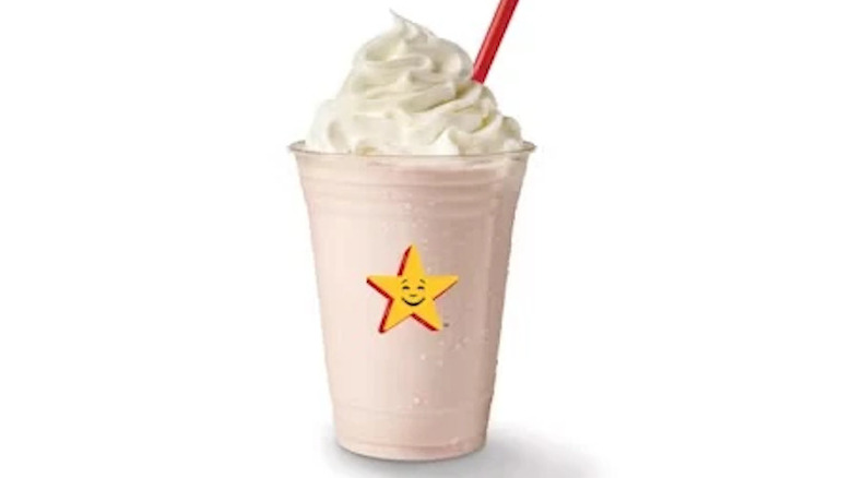 A sweet cherry shake from Hardee's with a red straw in it on a white background