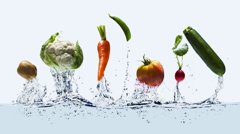 Assortment of produce splashing in water