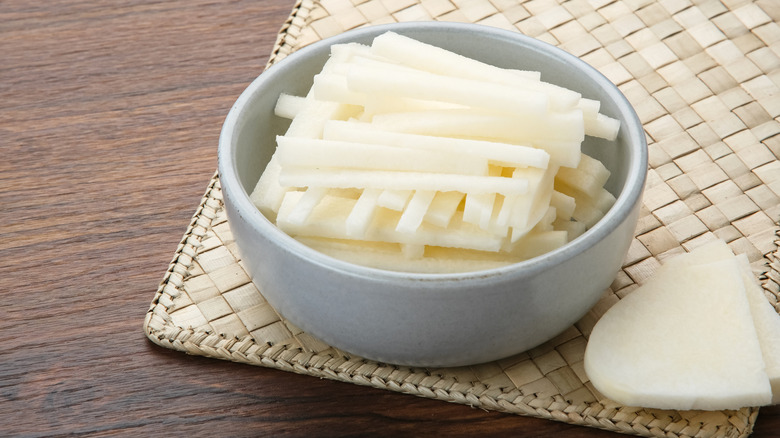 Peeled and sliced jicama in grey bowl