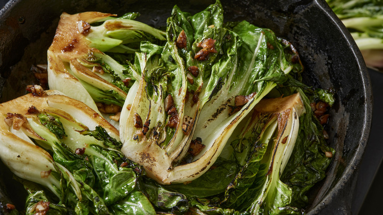 Glazed and grilled bok choy in cast iron pan
