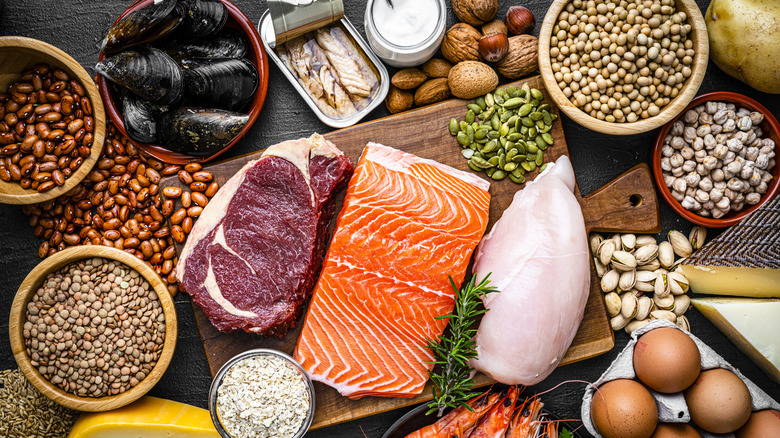 Overhead shot of an assortment of high-protein foods, including fish, meat, and legumes