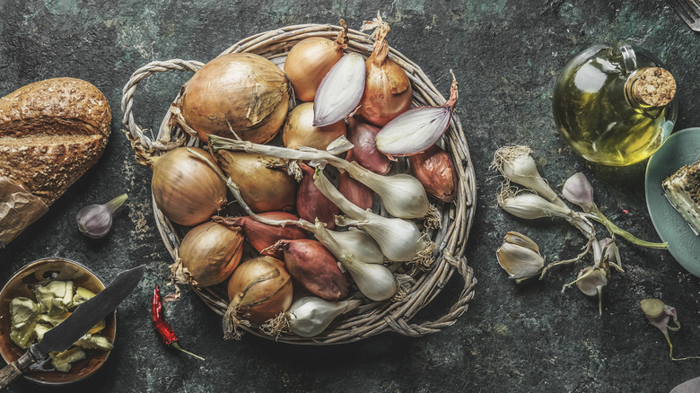A basket filled with different varieties of onions