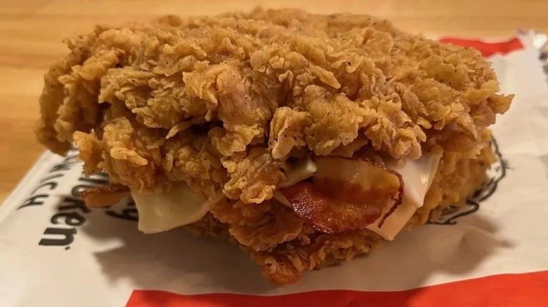 A close-up of a KFC Double Down sandwich on its wrapper
