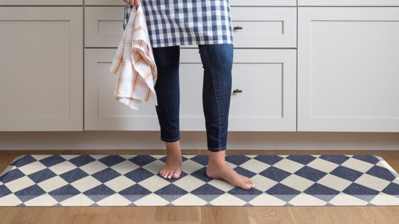 Person standing on the Crate and Barrel diamond mat