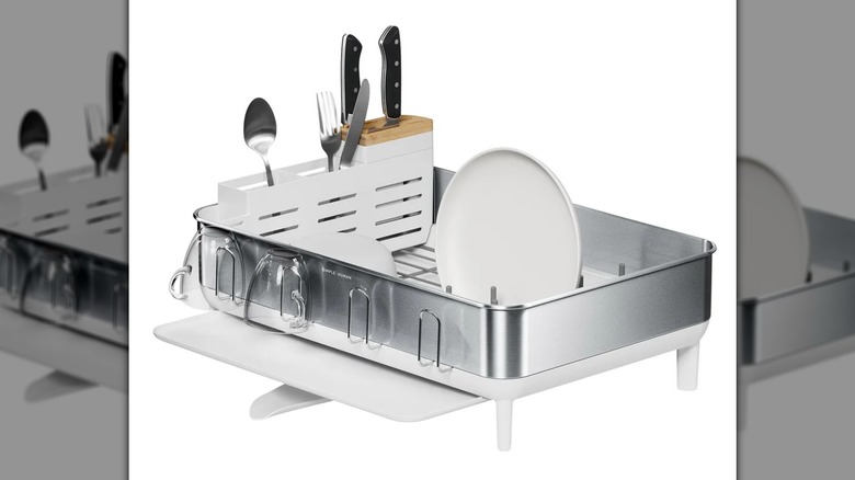 Simplehuman steel frame dishrack with bamboo knife block and some dishes and cutlery on white background