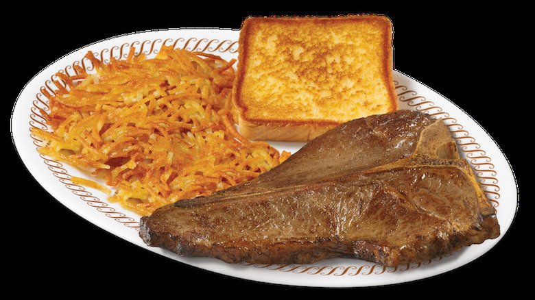 A plate of hash browns, toast, and a t-bone steak