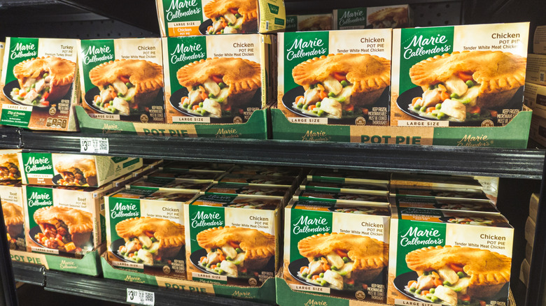 Many Marie Callender's chicken pot pie packages in a grocery store freezer