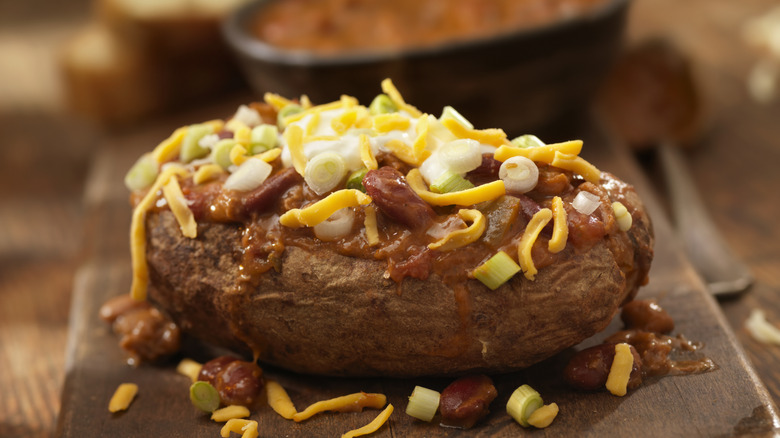Baked potato topped with chili, cheese, and sour cream.